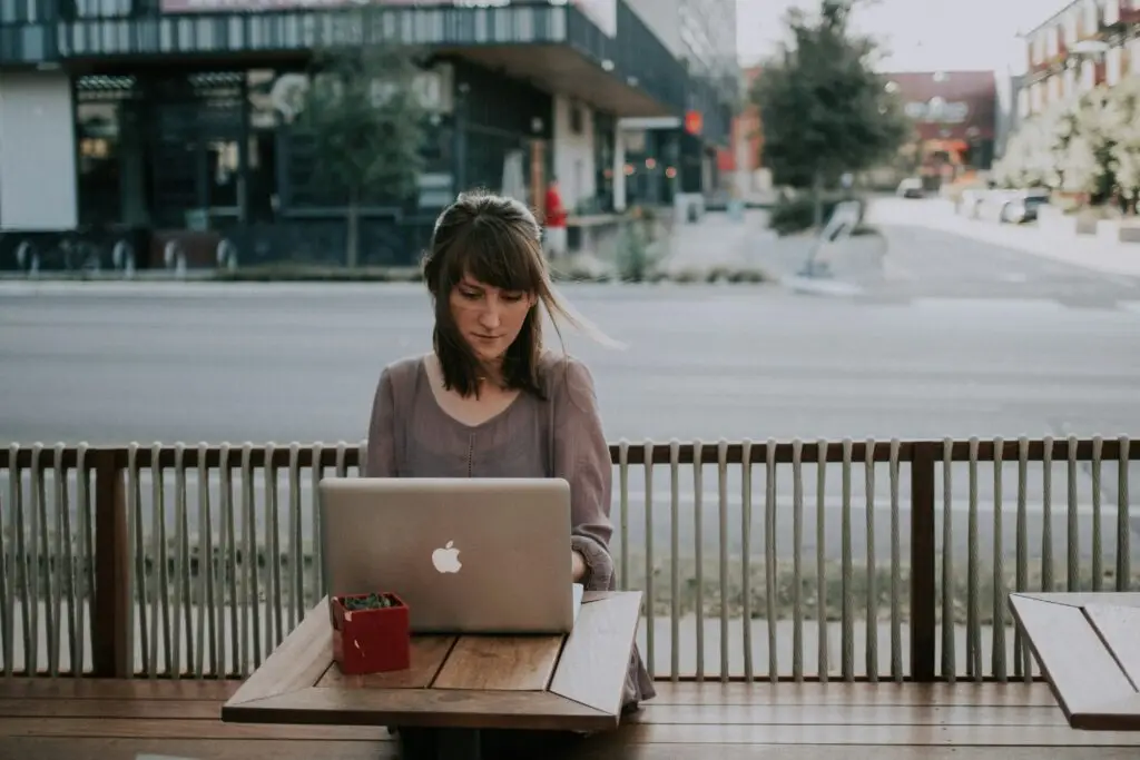 women sitting at table outside on computer studying for lcsw supervision in florida and texas